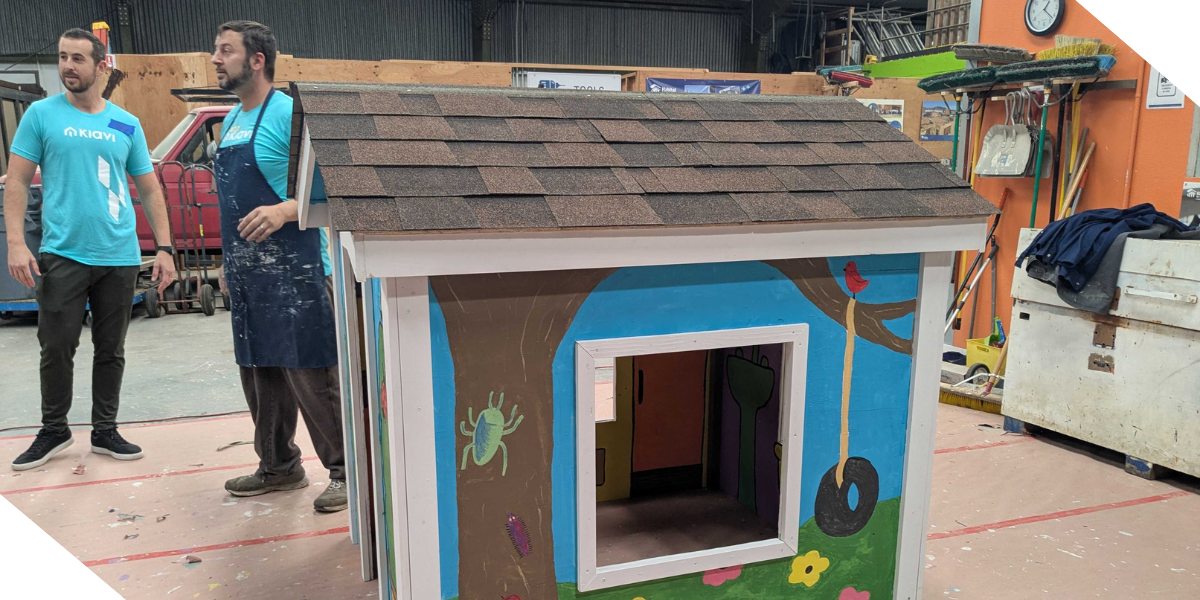 Kiavi employees are working on painting a colorful playhouse they’re helping Habitat for Humanity of Greater San Francisco build.