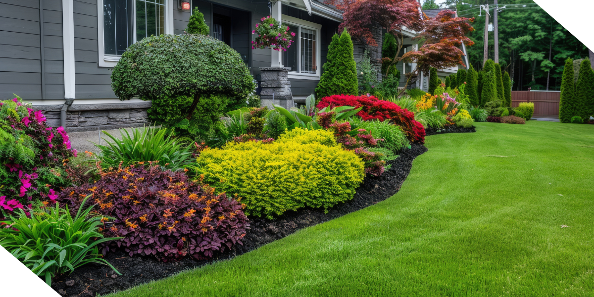 Fresh landscaping on a fix-and-flip property, featuring a colorful garden with vibrant flowers and shrubs next to the house, complemented by a neatly manicured green lawn in the foreground.
