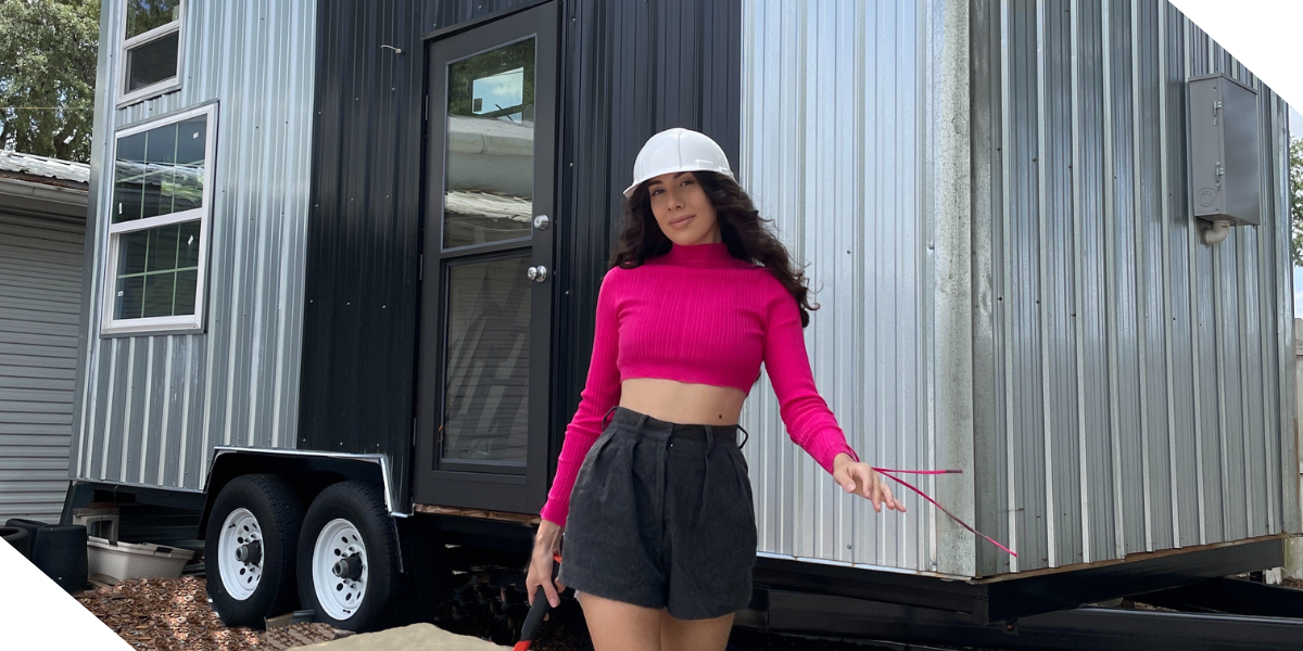 Tiffany Da Silva, a real estate investor, social media influencer,  and Kiavi customer, in front of one of her tiny home builds.