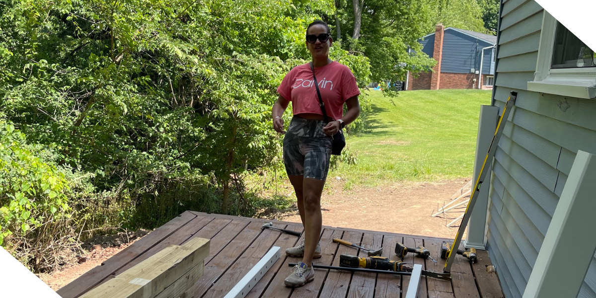 A photograph of Michelle Jimenez, a real estate investor in Pittsburgh, PA, working on a the patio of a new rental property.