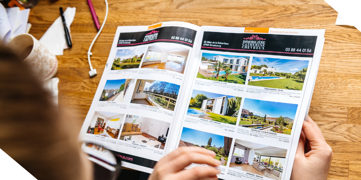 A real estate investor looks over the marketing materials for their new fix and flip investment property that is now for sale.