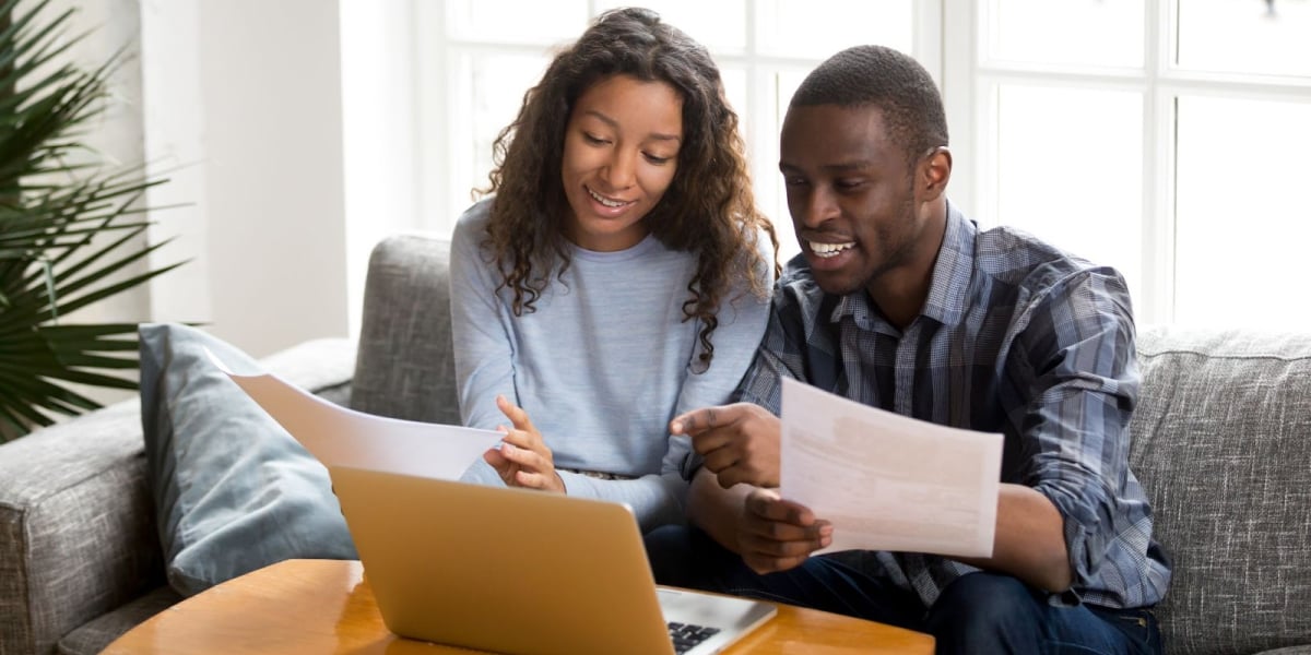 a real estate investor couple sitting down to review paperwork together