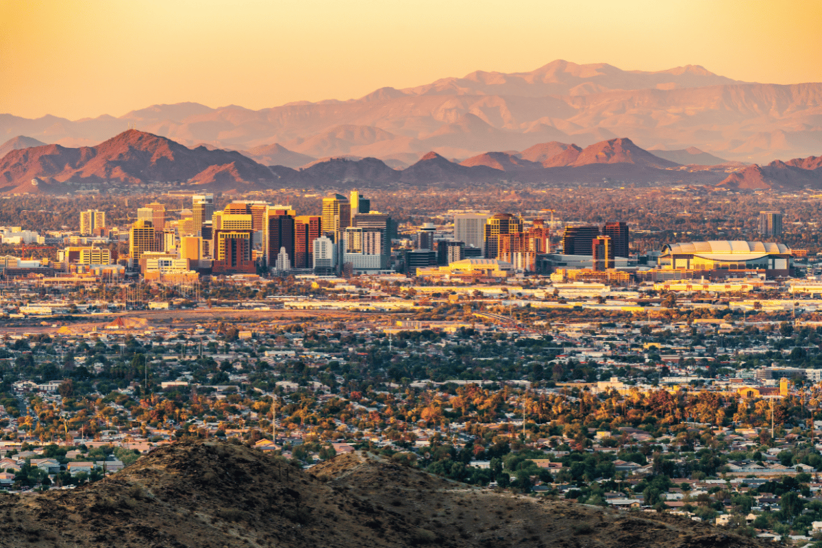 Tucson skyline at sunset, showing urban real estate investing options available with Kiavi financing.