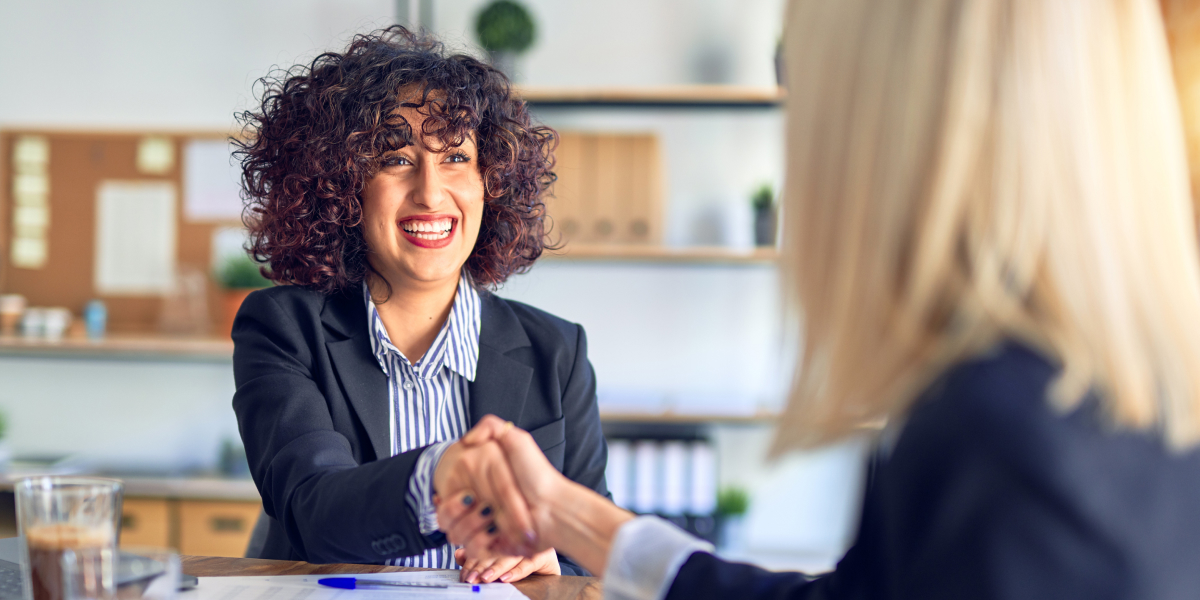 Smiling real estate agent shaking hands with a real estate investor