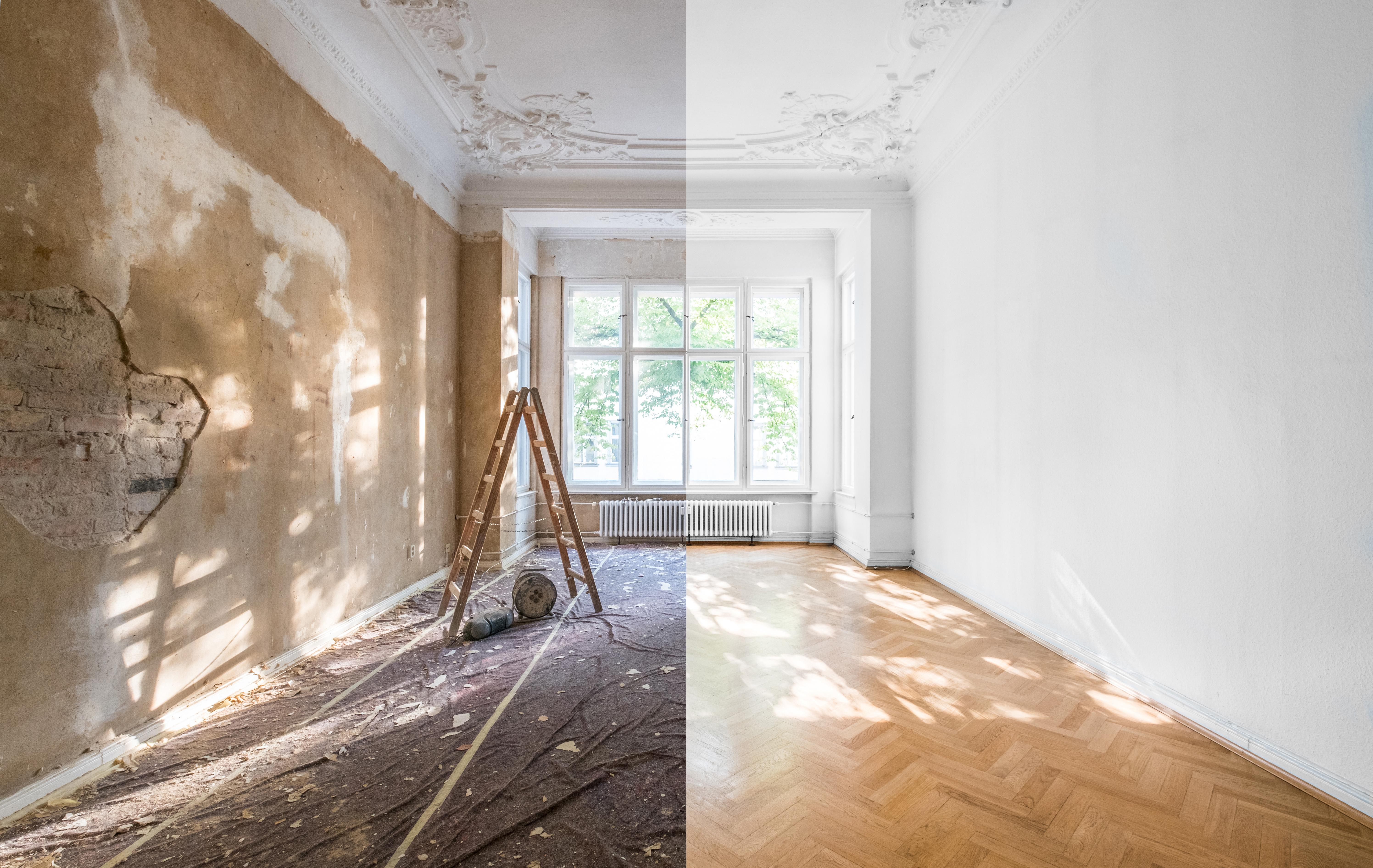 A fix-and-flip renovation in progress: one side of the room is under construction with exposed walls, while the other side is freshly painted and completed.