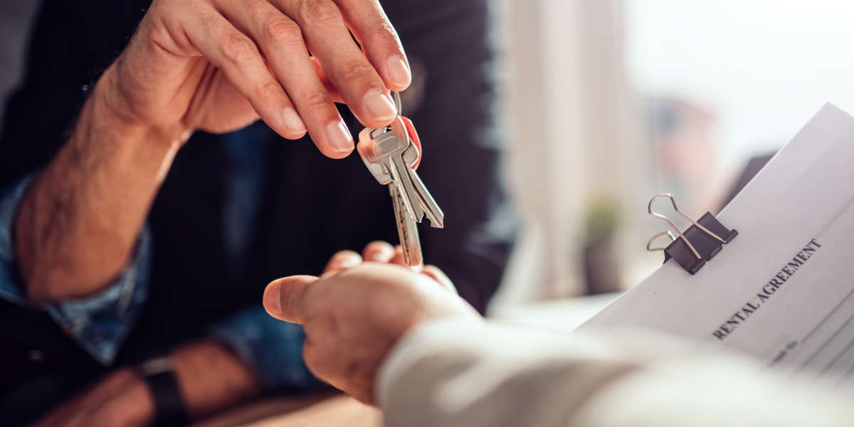 landlord giving keys to a tenant