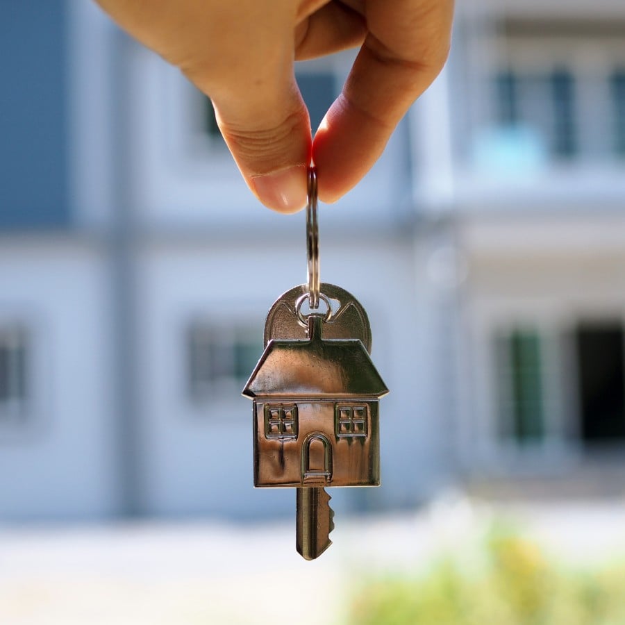 Close up of a landlords hand holding keys to a rental property