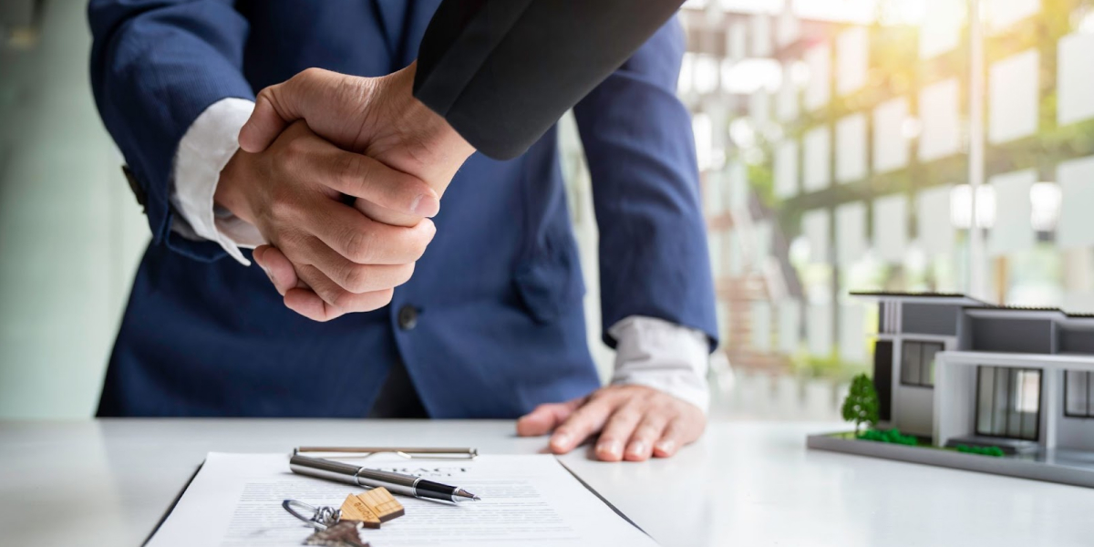 real estate investor shaking hands with a partner