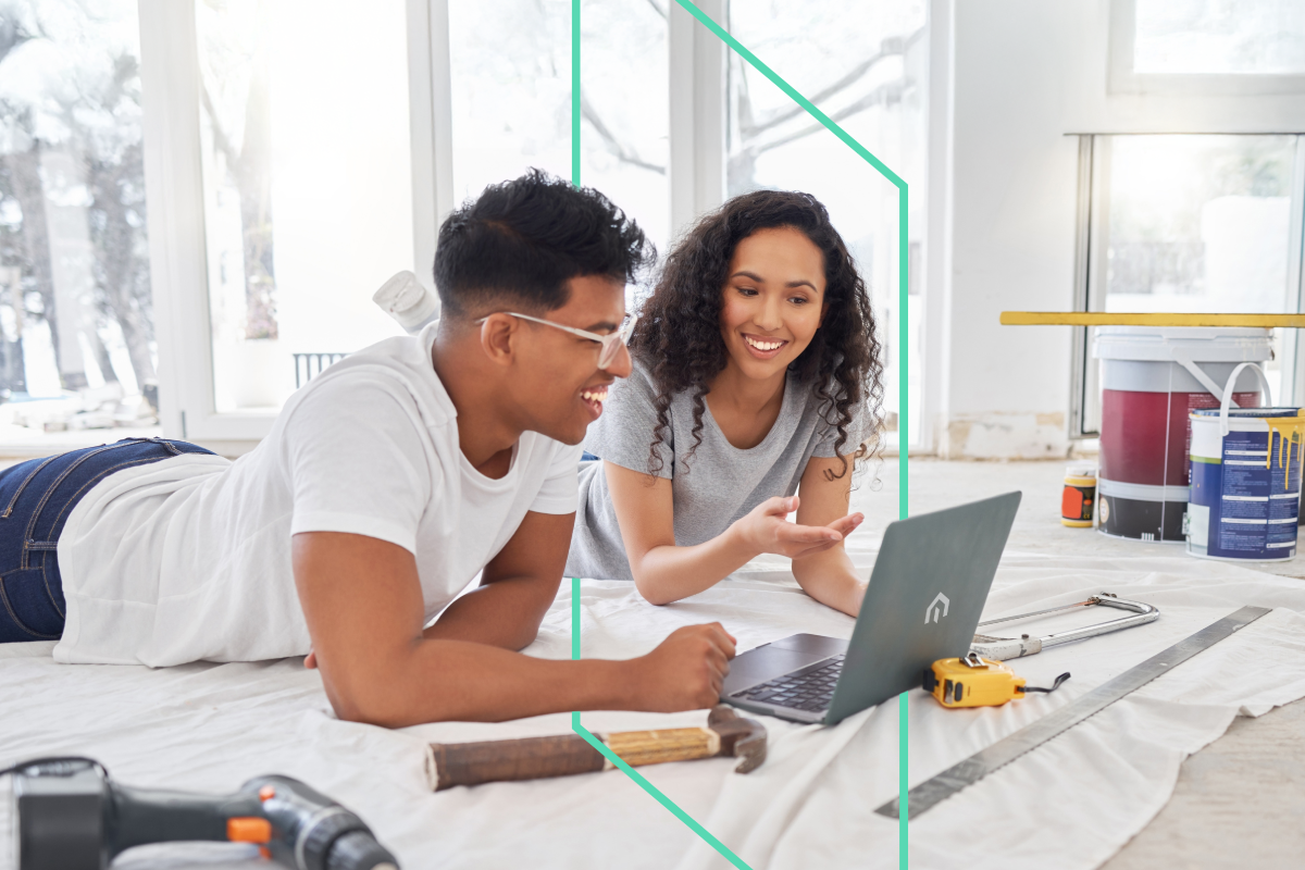Two real estate investors reviewing renovation plans on a laptop, strategizing their next investment property project with Kiavi.