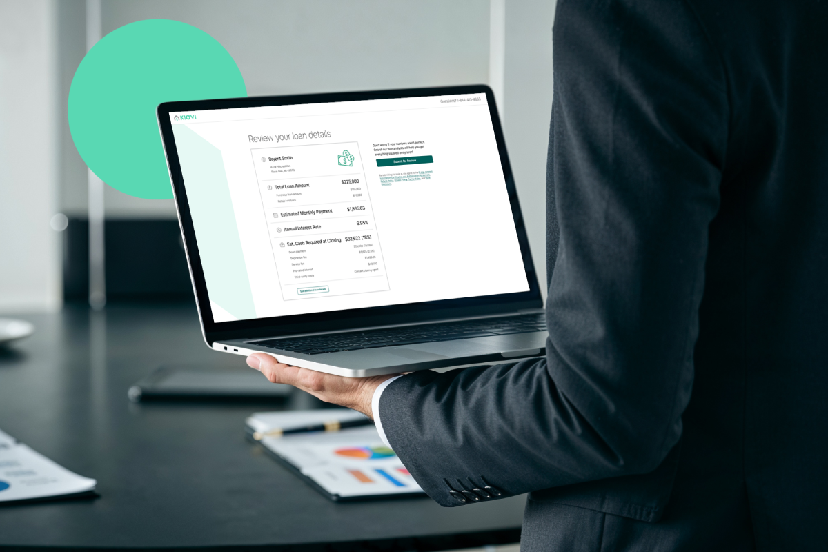 A real estate investor reviews loan details on a laptop, including loan amount, payment, and rate, powered by Kiavi.
