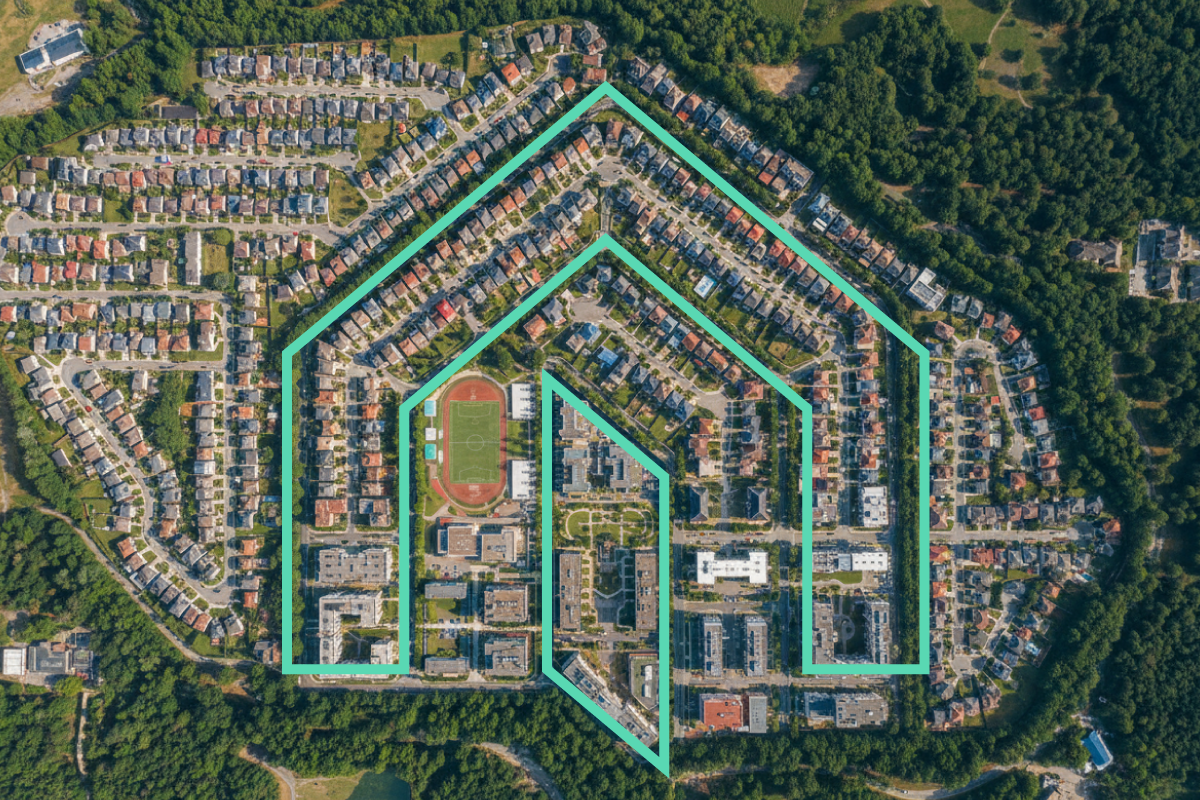 Aerial view of a residential neighborhood with houses, roads, and a sports field. 