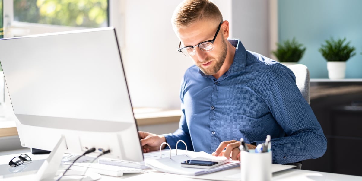 real estate investor calculating numbers in front of a computer