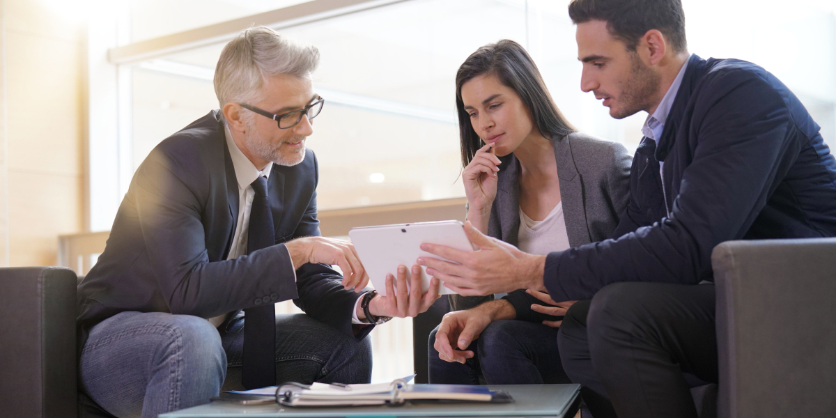 A couple of real estate investors going over documents with their real estate agent