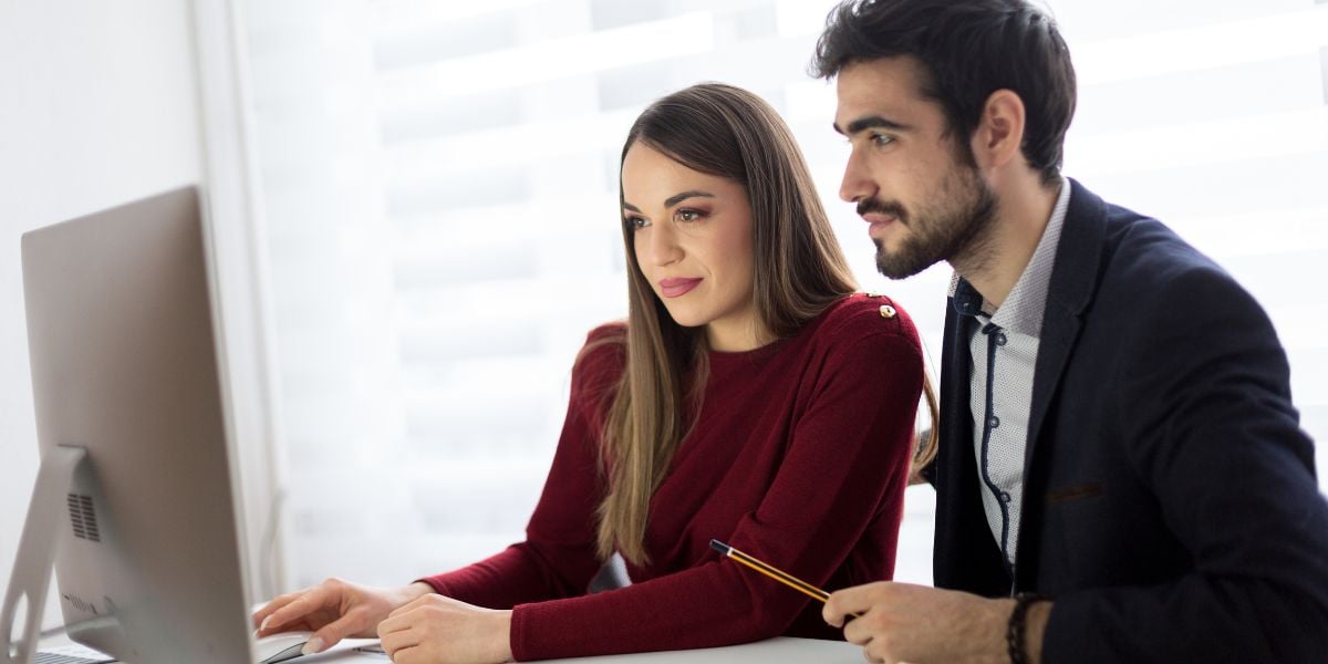  Real estate investor and her trusted lending partner collaborating on a computer