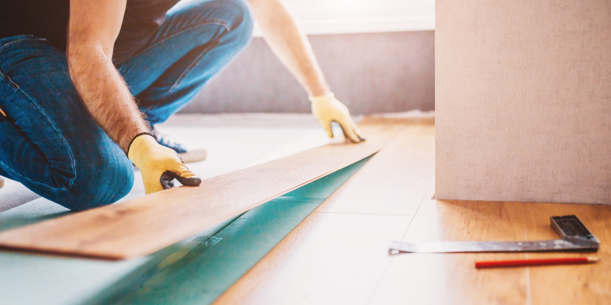 close up of a house flipper laying new flooring