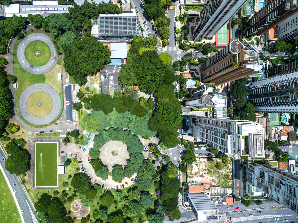 A bird's eye view of a city with high rises, condos, and parks.