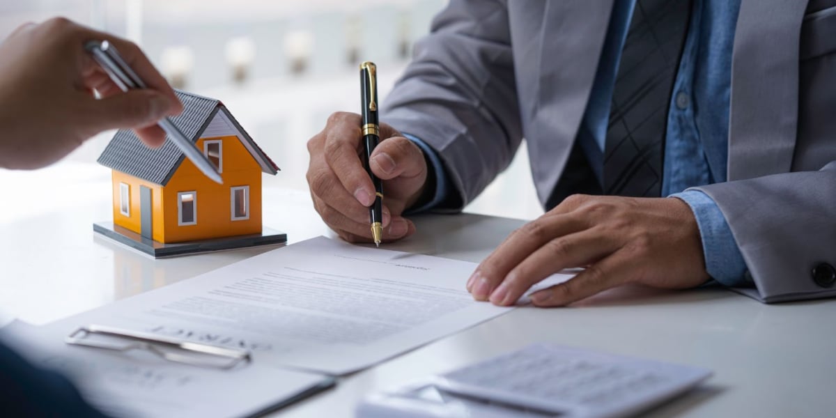 close up of a real estate investor signing loan documents