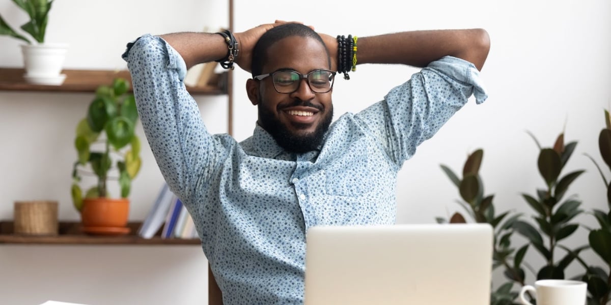 image of a real estate investor smiling in front of a computer