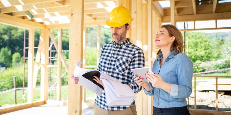 real estate investor talking to general contractor at an infill construction site