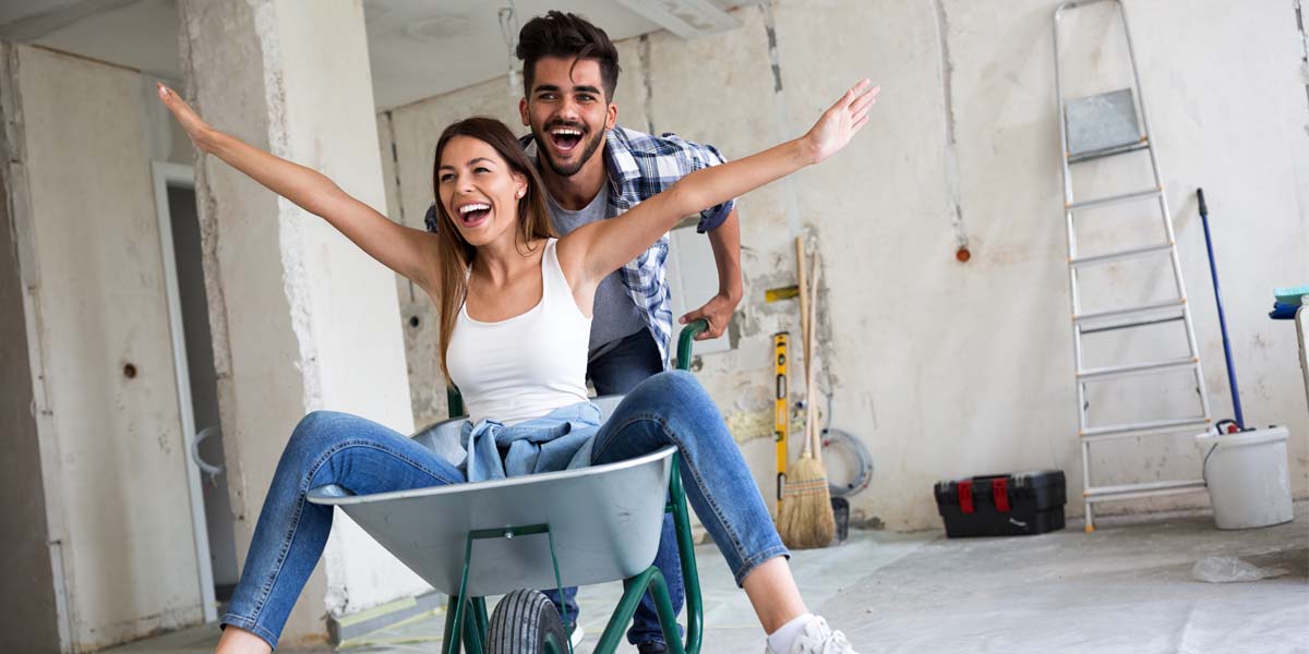 excited house flipping couple working on a renovation