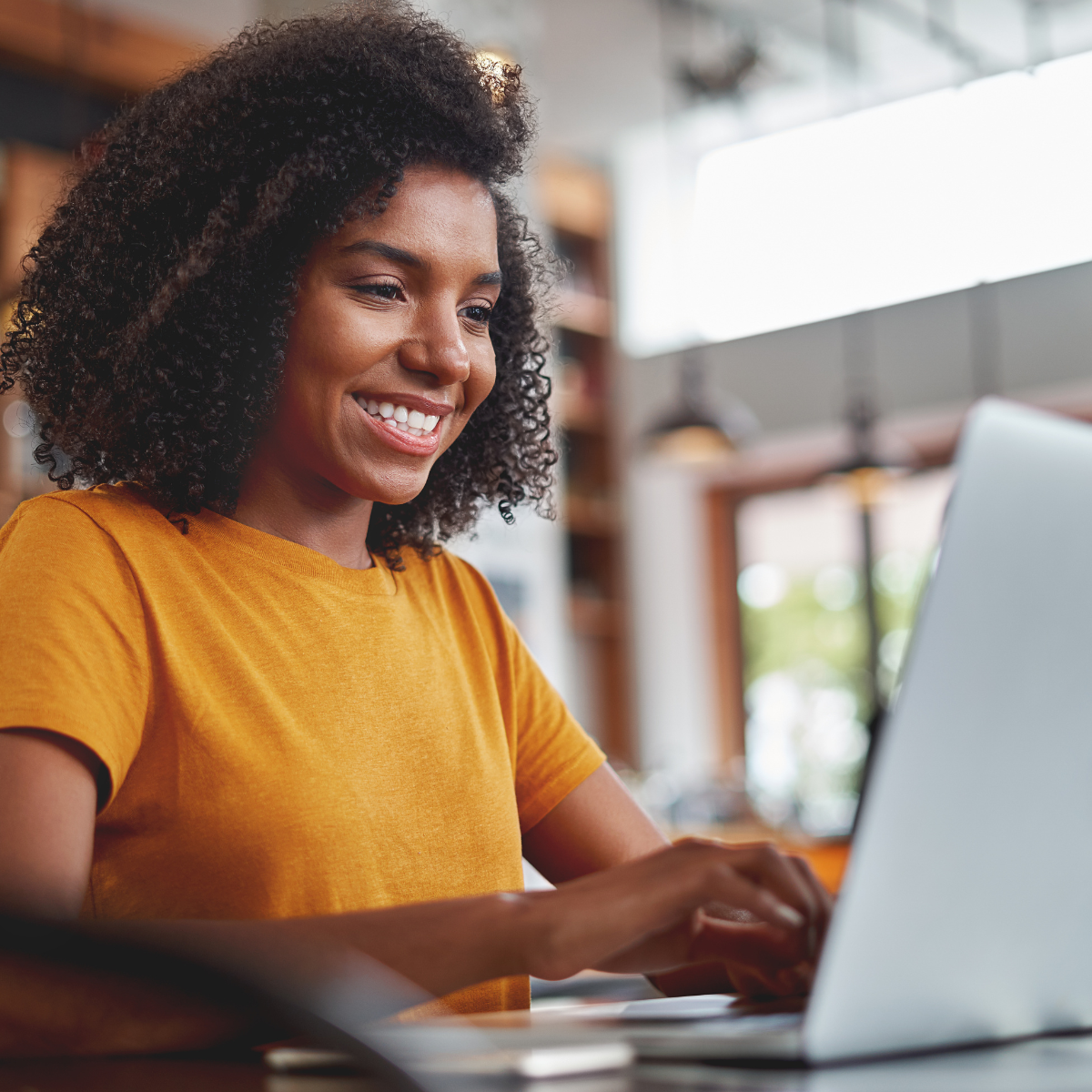 happy_female_REI_looking_at_laptop