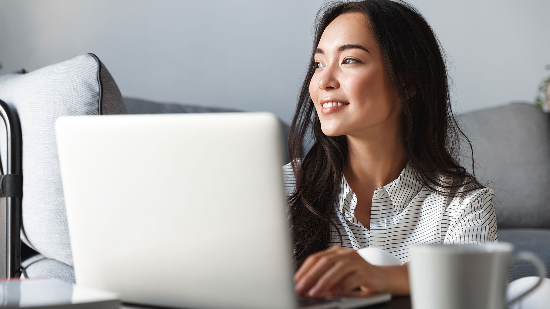 A real estate investor smiling at their laptop
