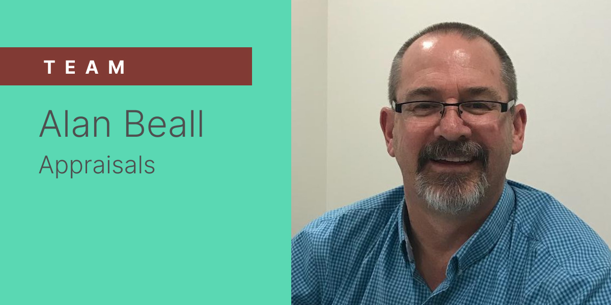 A company branded banner featuring Alan Beall.